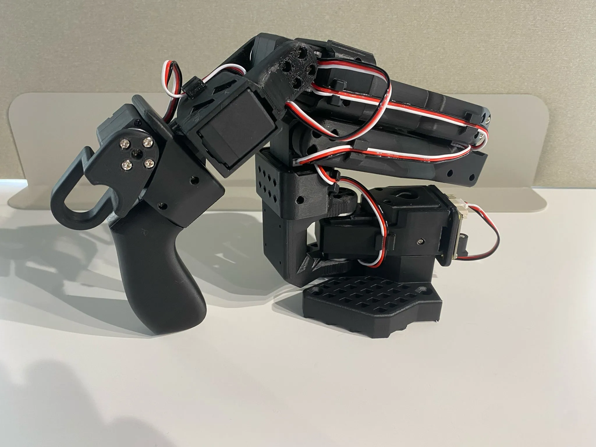 SO-101 leader arm with a handle and trigger for teleoperation